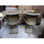 A pair of patinated cast iron garden pedestal urn shaped pot, twin handles, relief cast floral