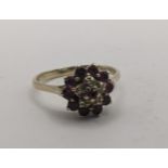 A 9ct yellow gold ruby and white sapphire/moissanite daisy cluster ring, 2.35g, Location:
