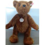 Steiff - a 2016 brown teddy bear no 664946 with original tags intact and box, 28cm high, together