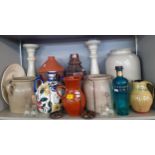 A quantity of pottery jugs, mainly continental together with mixed candlesticks and holders.