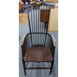 An Arts & Crafts Liberty style armchair having spindle supports and tapered front legs Location: