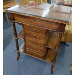 An early 20th century French walnut work table having a hinged top with a fitted interior, reeded