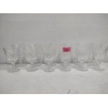 A set of six red and white wine drinking glasses with cut glass bowls and domed feet Location: