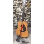 A Yamaha DW15 6-string natural and rosewood acoustic guitar with shoulder strap and Ultimate