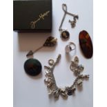 A small quantity of costume jewellery to include a Ruskin glazed pottery brooch, a silver charm