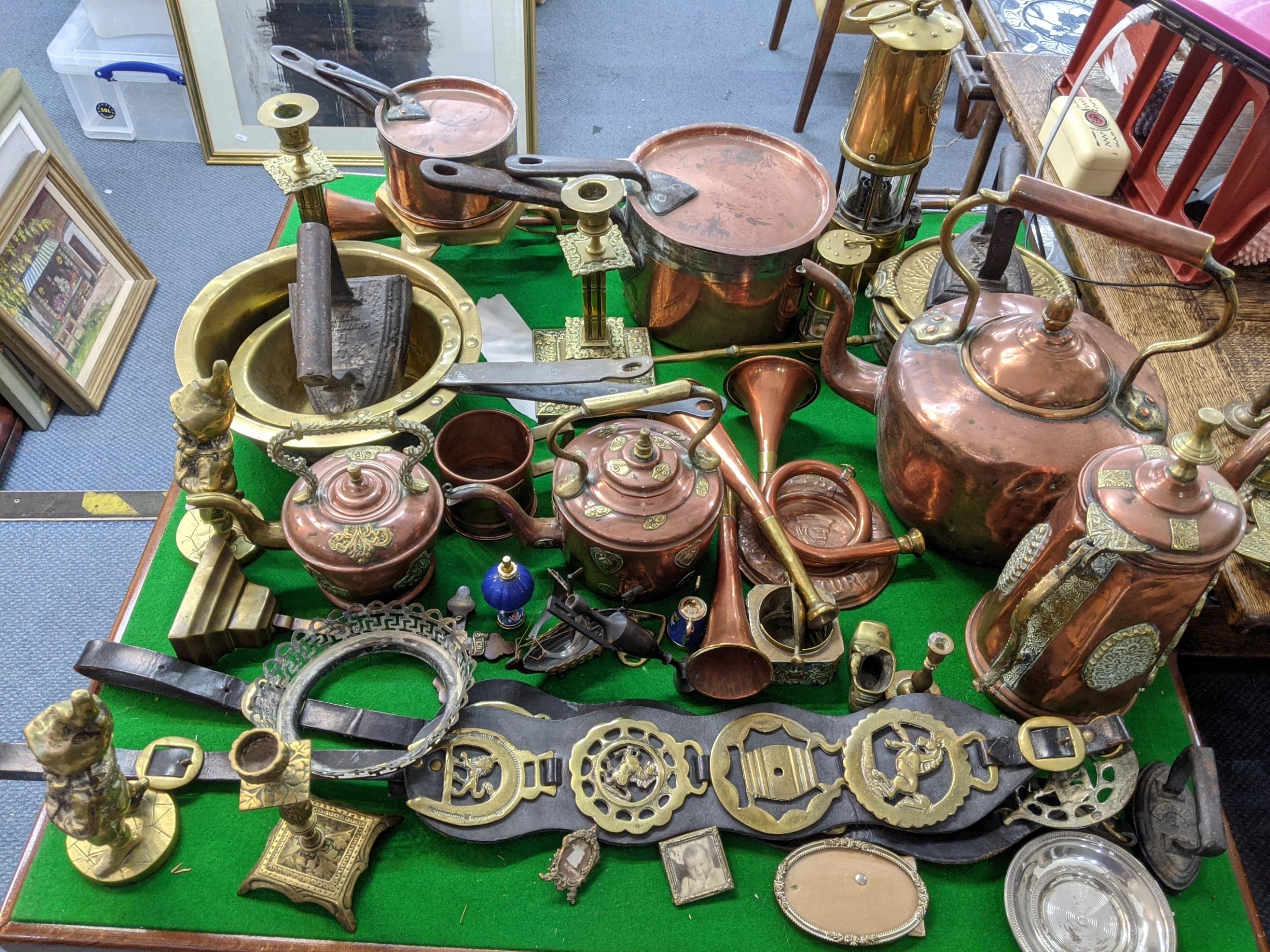 A collection of 19th century and later copper and brassware to include a set of Victorian pans