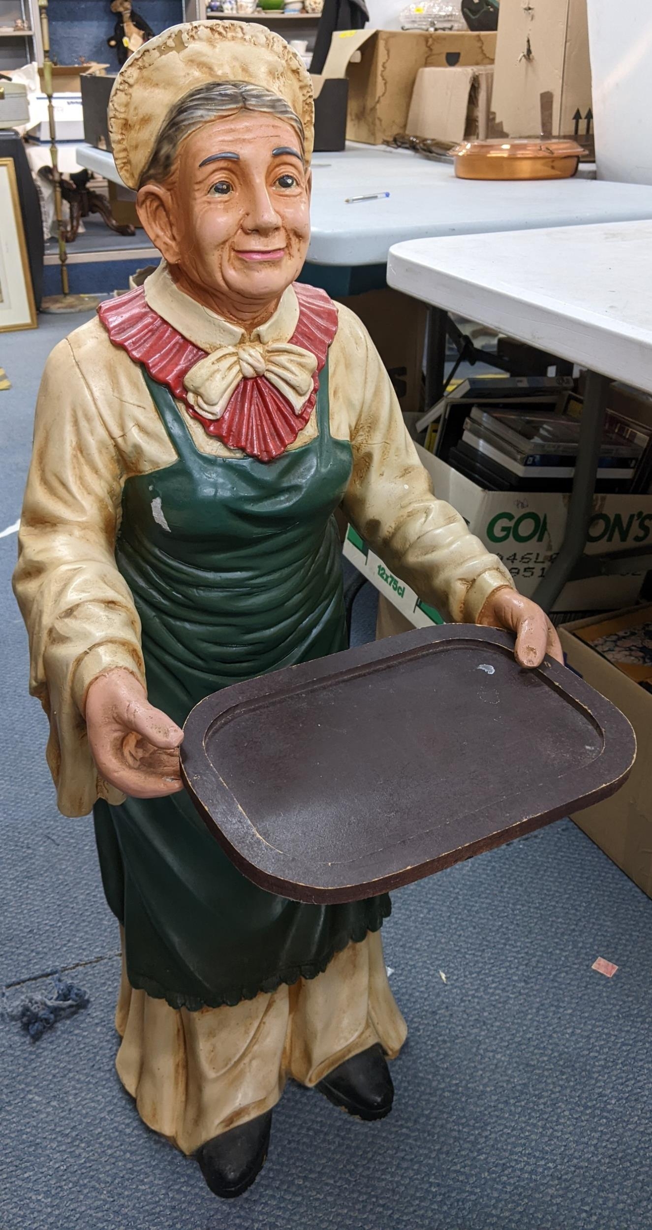 A late 20th century composition waiter fashioned as an old lady carrying in tray, 96cm h Location: