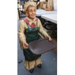 A late 20th century composition waiter fashioned as an old lady carrying in tray, 96cm h Location: