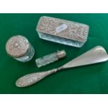 Four early 20th Century dressing table items to include a silver handled shoe horn and 2 silver