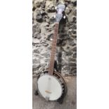 A Remo Godman weatherking banjo with 5 pearlised pegs and a stand