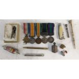 Collectables to include propelling pencils, miniature medals, a silver coloured tape measure, pen