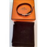 Hermes- A BeHapi bracelet in black Chamonix calfskin with silver-plated Hapi closure designed by