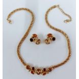 Christian Dior-A 1980's gold tone jewellery suite comprising a gold tone necklace with amber