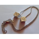 Christian Dior-A silver necklace having two branded dice pendants and a D for Dior pendant to the