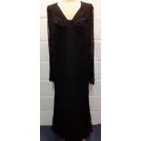 A 1920's/30's black sheer evening dress with button mesh lace to the arms and lower skirt having a