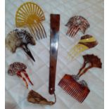 A quantity of early 20th Century hair combs to include horn examples and faux tortoiseshell with