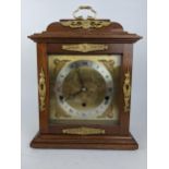 A reproduction Elliott bracket clock retailed by Harrods, the case having a stepped pediment with