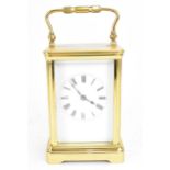 A 20th century French carriage clock, the brass case with bevelled glass panels, enclosing a white