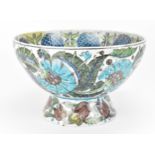 A large William de Morgan style Iznik palette punchbowl, in the Persian blue carnation pattern on