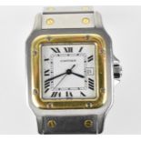 A Cartier Santos, automatic, gents, stainless steel and gold wristwatch, having a white dial with