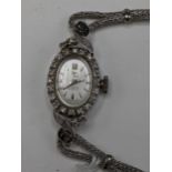 A Filippe Girard manual wind, ladies 14k stamped white gold cased wristwatch inset with 24 diamonds,