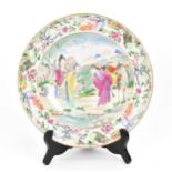 A Chinese Famille Rose plate, Qianlong/Jiaqing period, late 18th/early 19th century, depicting a