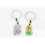 Two Chinese modern jade pendants, one with pierced mottled green fruit pendant hanging on the