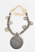 An Omani thaler necklace, with central large circular sunburst disc pendant, and six silver Maria