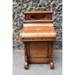 A Victorian burr walnut piano Davenport, circa 1870, the pop-up top with fret-work letter