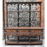 A George III oak open potboard dresser, in two sections, designed with moulded cornice above three