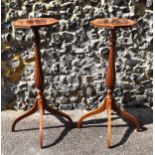 A pair of Edwardian mahogany torcheres, in the Georgian style, the octagonal tops with flame veneer,