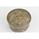 A Chinese export silver oval lidded box, circa 1900, embossed with dragons in clouds, the underside