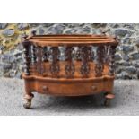 A Victorian figured walnut two division music canterbury, of oval outline, with a spindle and fret