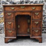 An early George III burr walnut and feather-banded kneehole desk, the bookmatched veneer top with