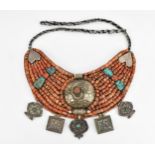 A Tibetan or Nepalese coral, turquoise and white metal bib necklace, late 19th/early 20th century,