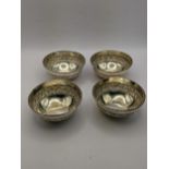 Four silver bowls, stamped silver to be bottom having embossed engraved decoration, total weight