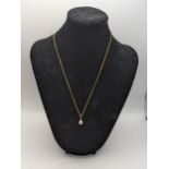 A 9ct gold necklace having a 9ct and seed pearl pendant, total weight 3g. Location: