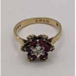 A 9ct gold ruby and diamond ring in the form of a flower, total weight 2.8g