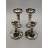 Silver compromising a pair of weighted vases and sward candlesticks. Location: