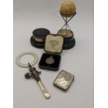A mixed lot of silver to include a silver vesta case having engraved detail, a trophy in the form of