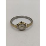 A 9ct gold vintage ladies Accurist manual wind wrist watch and a gold plated expanding bracelet