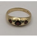 A 9ct gold gypsy ring set with red garnets total weight 3.1g Location: