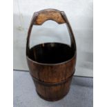 A 19th century Chinese well bucket with integrated handle and wrought iron supports., 61h Location: