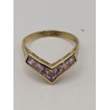 A 9ct gold pink cubic zirconia wishbone ring, total weight 2.7g Location: