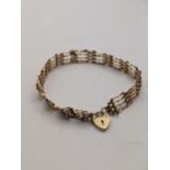 A 9ct gold gate link bracelet, with a heart clasp total weight 4.9g Location: