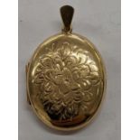 A 9ct locket with engraved decoration to the front of flowers and foliage, 9.4g Location: