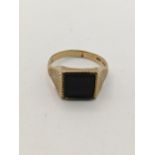 A 9ct gold and black onyx plaque ring, total weight 3.8g Location: