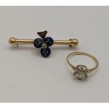 A yellow metal bar brooch, the centre decorated with lapis lazuli and inset with old cut diamonds,