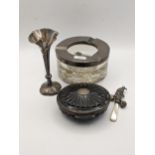 Silver items to include a weighted vase, mother of pearl and silver rattle, a silver and tortoise