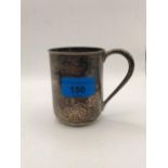 An early 20th century silver Christening mug with engraved initials decorated with flowers and